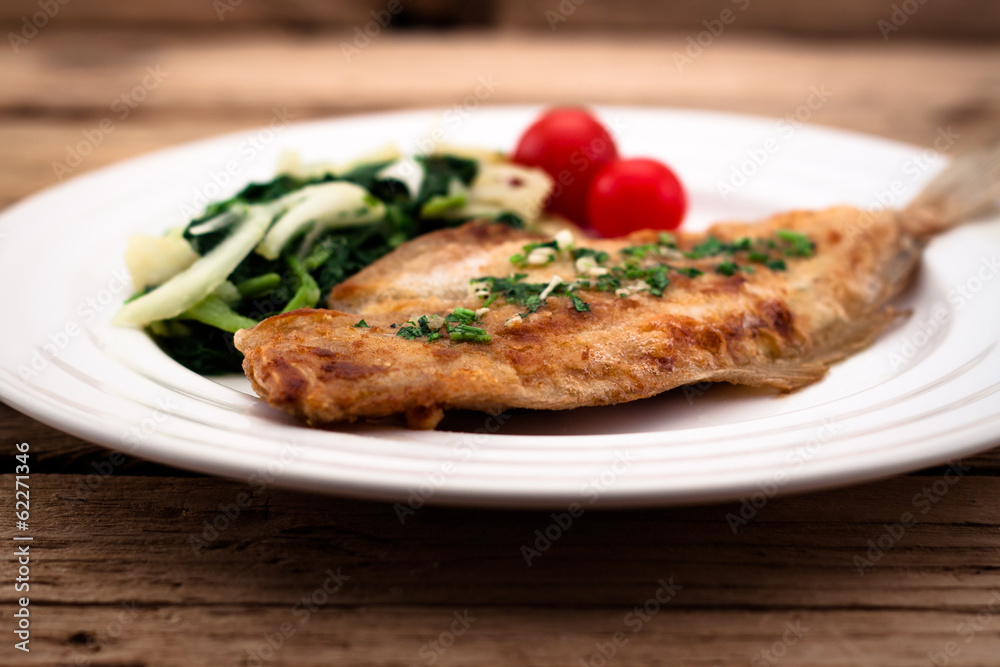 Fried flounder with onion, cabbage and potato