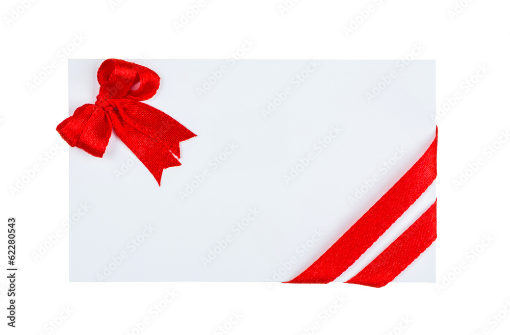 Close up of card with red ribbon bow on white background Close up of card with red ribbon bow on white background