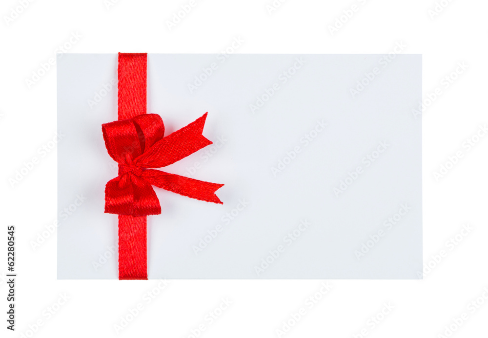 Close up of  card with red ribbon bow on white background