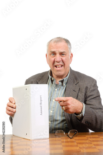 Baby-boomer businessman with annual report isolated on white