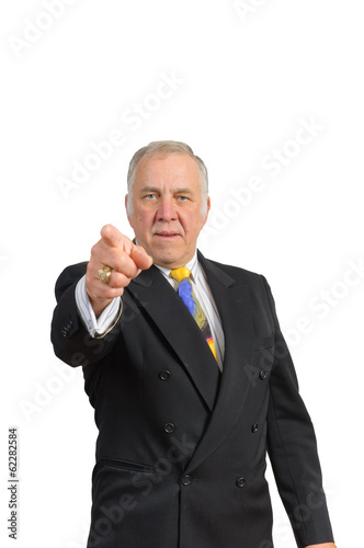 older businessman in a suit and tie pointing towards the viewer over a white background photo