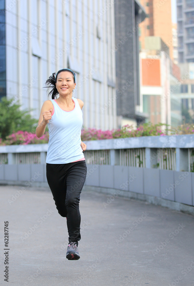 healthy lifestyle woman jogging at city foot bridge
