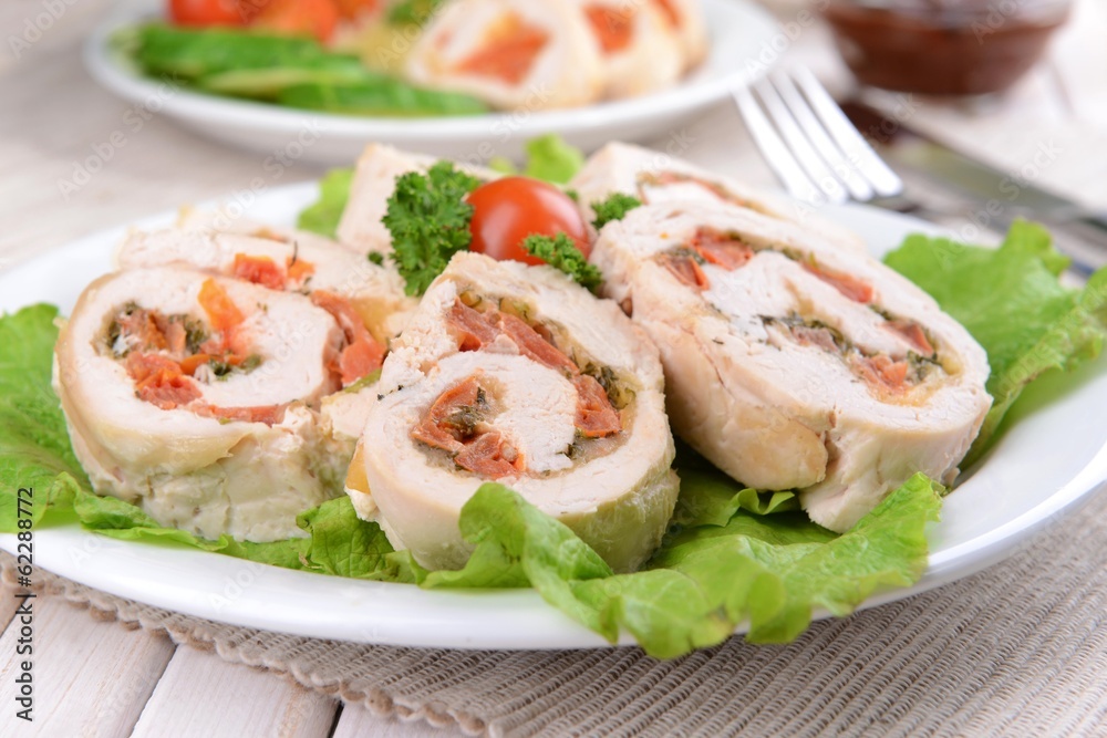 Delicious chicken roll on plate on table close-up Delicious chicken roll on plate on table close-up