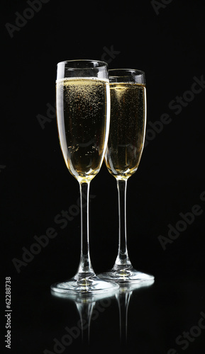 Glasses of champagne, on black background