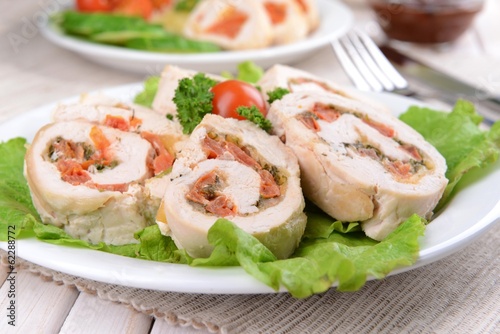 Delicious chicken roll on plate on table close-up