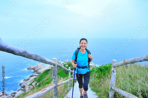 woman hiker on seaside mountain peak © lzf