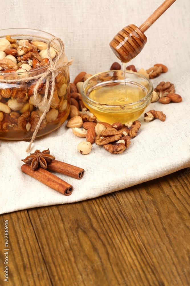 Sweet honey and different nuts on wooden table Sweet honey and different nuts on wooden table