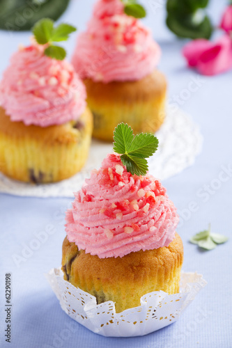 Muffins with whipped cream and strawberries.