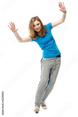 Playful young woman balancing tilted sideways