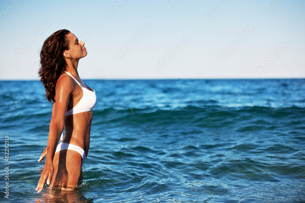 Young woman enjoying summer rest at the seaside. Young woman enjoying summer rest at the seaside.