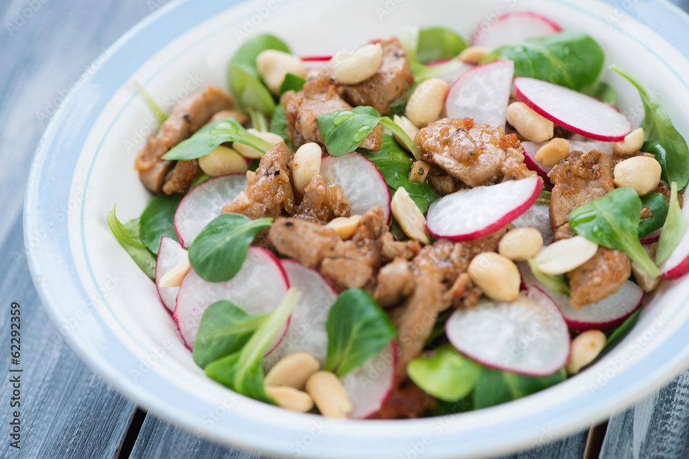 Salad with radish, roasted meat, corn salad leaves and peanuts Salad with radish, roasted meat, corn salad leaves and peanuts