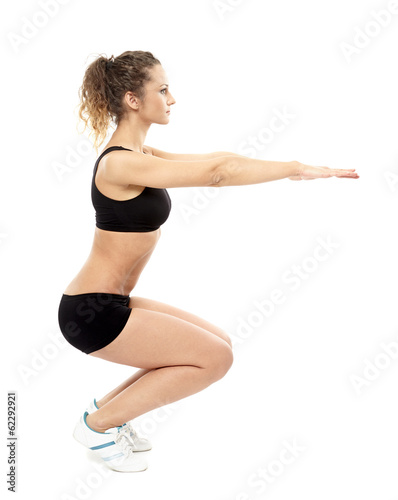 Athletic woman doing squats © Xalanx