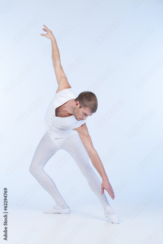young ballet dancer practicing in white.