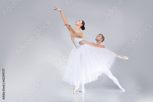 two young ballet dancers practicing.