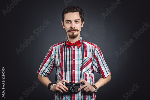 Portrait of a cheerful photographer in studio