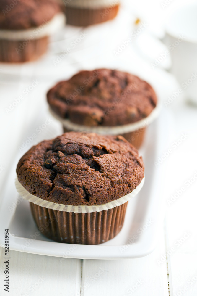 chocolate muffins on white table chocolate muffins on white table