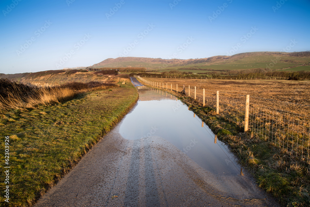Landscape image of flooded country lane in farm
