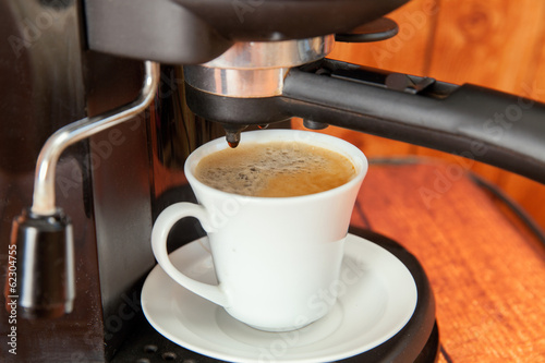The cup of espresso in coffee maker