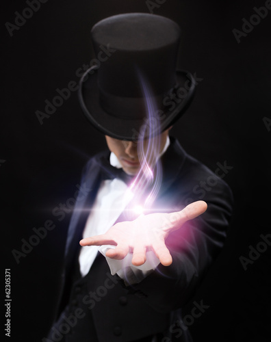 Fotografering magician holding something on palm of his hand