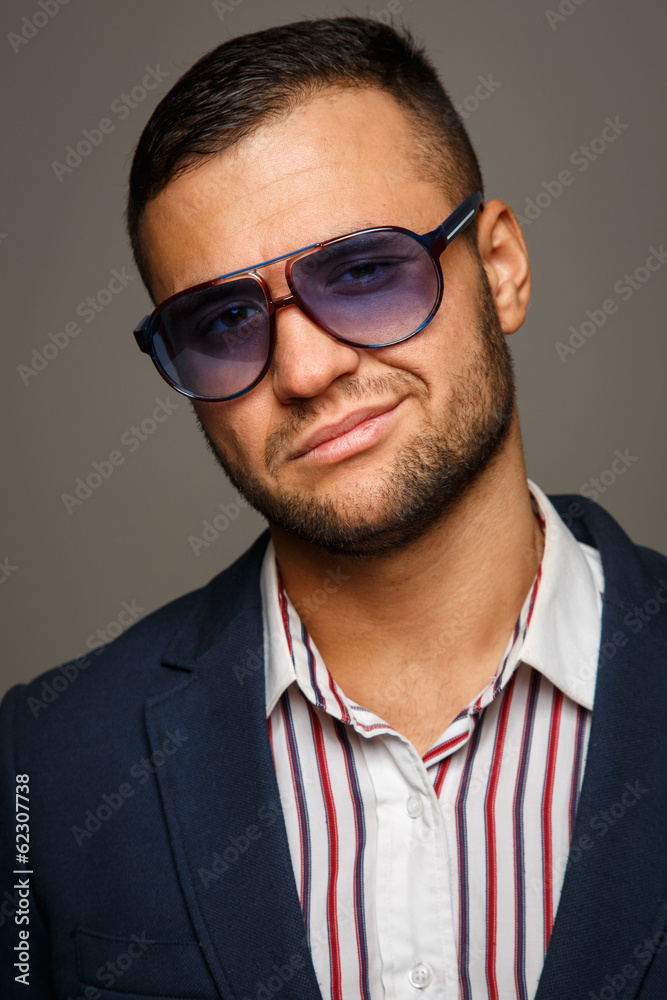 Portrait of a stylish successful businessman in sunglasses Portrait of a stylish successful businessman in sunglasses