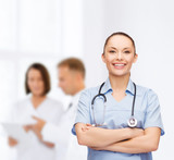 smiling female doctor or nurse with stethoscope