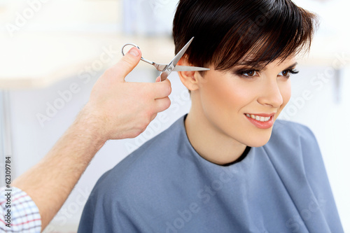 Brunette with Short Hair in Hair Salon. Hairdresser 