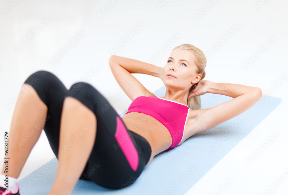 sporty woman doing exercise on the floor sporty woman doing exercise on the floor