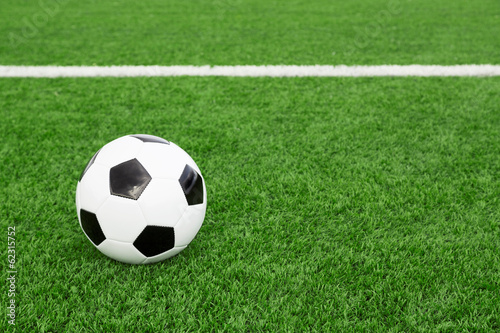 Traditional soccer ball on soccer field