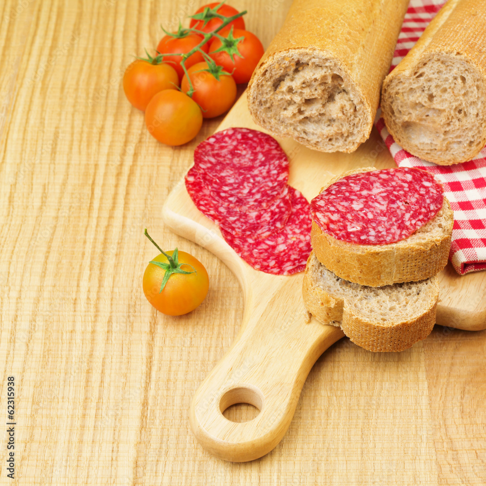 Sandwich with sliced meat sausage salami and tomatoes Sandwich with sliced meat sausage salami and tomatoes