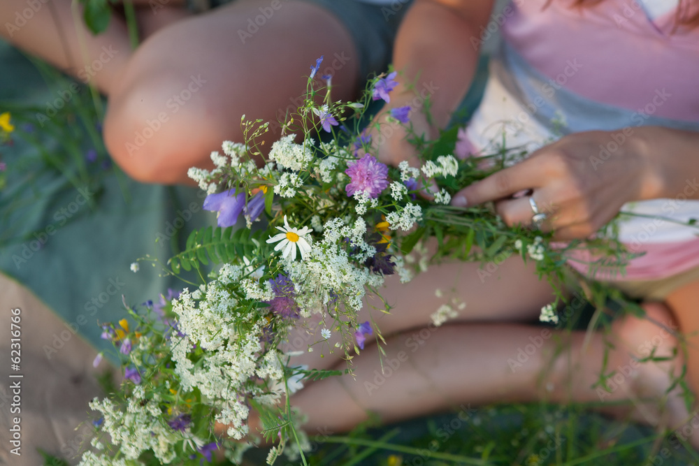 Girls make summer bouquet with grass and flowers. Girls make summer bouquet with grass and flowers.