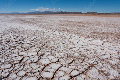 Flat saline desert, with dry and cracked ground in Bolivia.