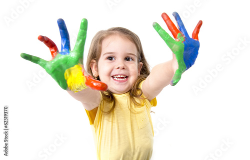 happy little girl with hands painted in vivid colours