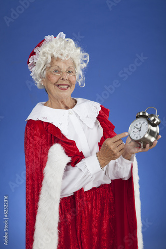 Mrs Claus showing a clock and its almost Christmas