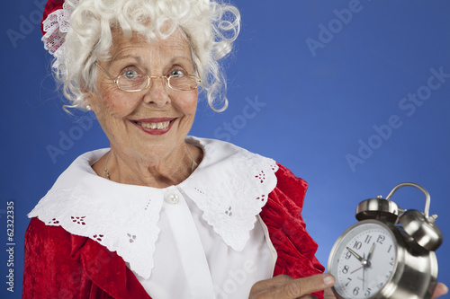 Mrs Claus showing time on a clock