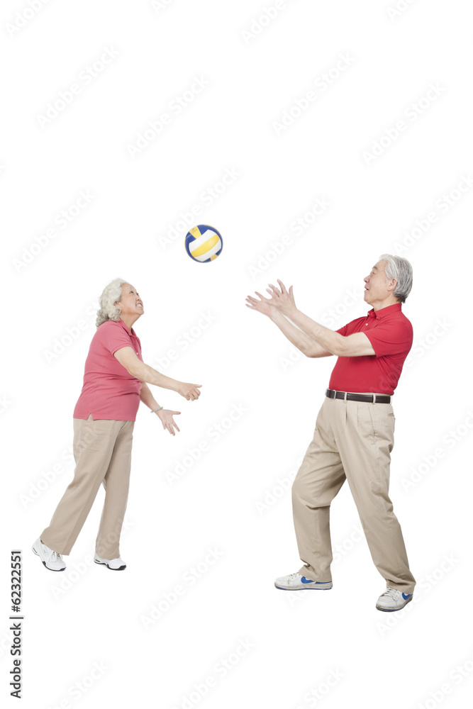.Senior couple holding volleyball. .Senior couple holding volleyball.