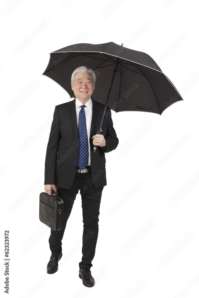 .Senior businessman with briefcase and umbrella. .Senior businessman with briefcase and umbrella.
