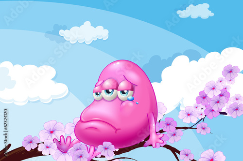 A pink monster at the branch of a tree