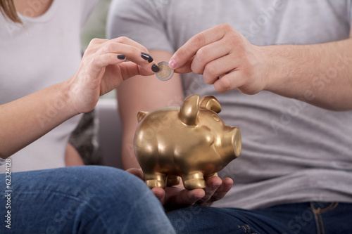 Couple saves money with piggy bank
