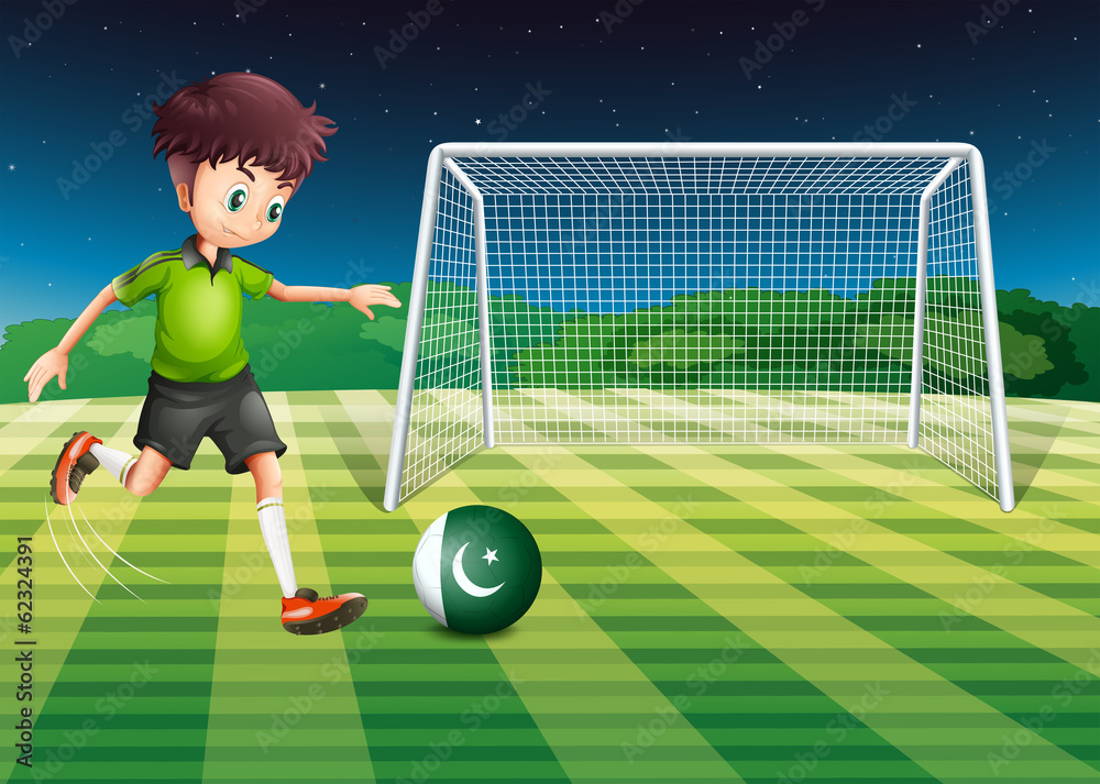 Fototapeta premium A male player kicking the ball with the flag of Pakistan
