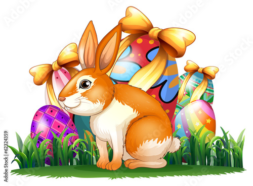 A cute bunny in front of the Easter eggs