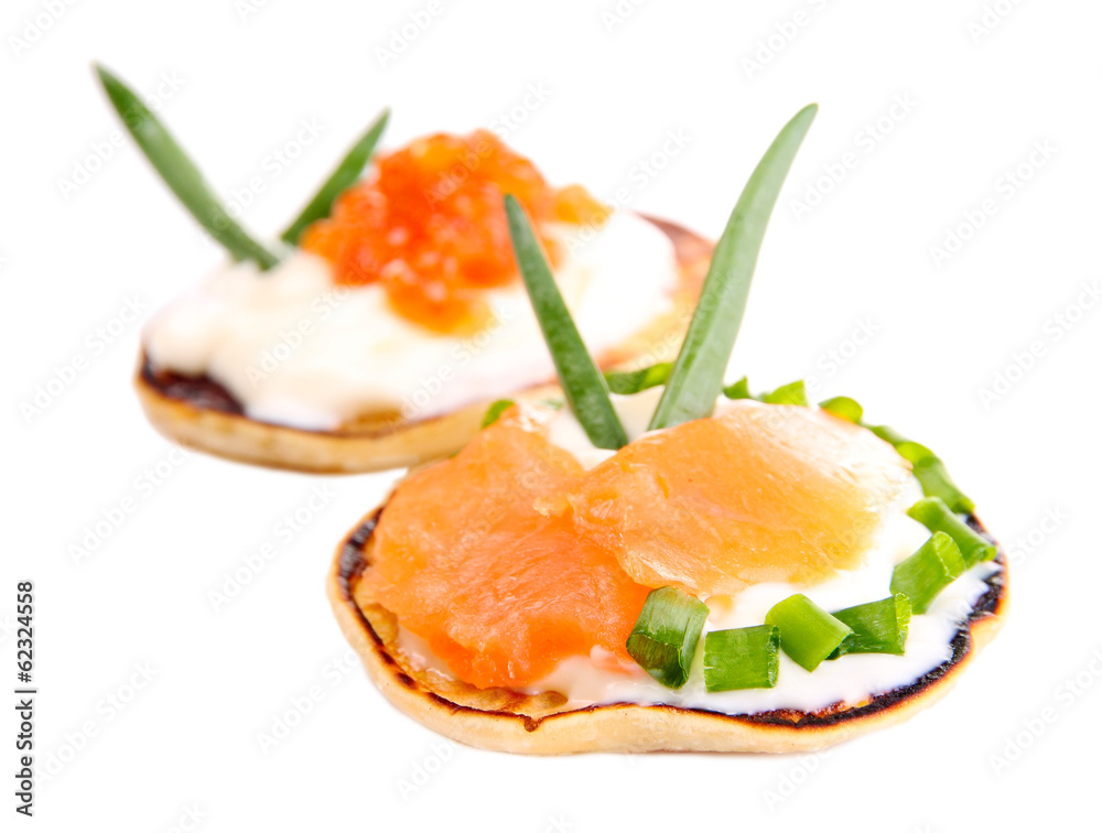 Pancakes with red caviar and salmon, isolated on white Pancakes with red caviar and salmon, isolated on white