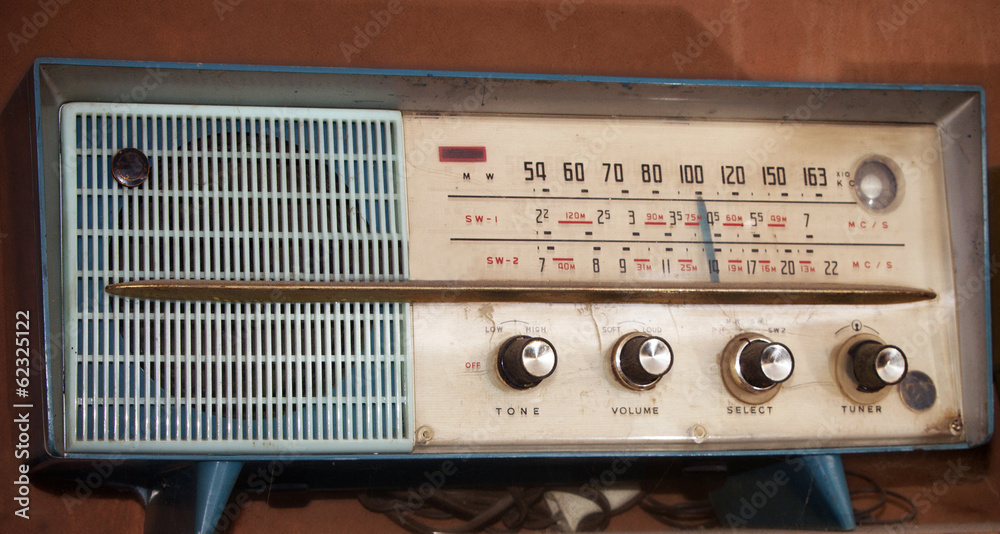 Fototapeta premium vintage radio on a wooden shelf (toned image )