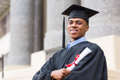 african american male graduate standing outside college photo