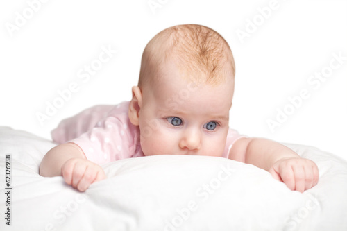 little girl lies on a pillow