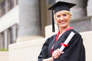 middle aged woman with graduation cap and gown