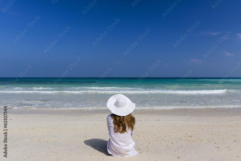 Woman sat up looking at the tropical paradise. Woman sat up looking at the tropical paradise.