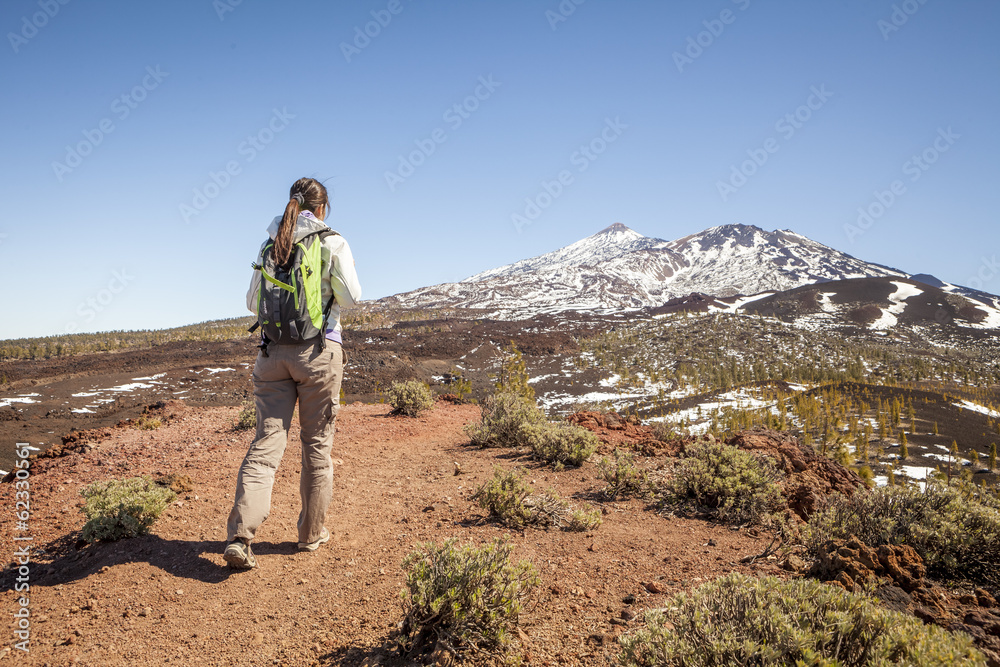 young woman on top of a mountain enjoying the view of volcano te young woman on top of a mountain enjoying the view of volcano te