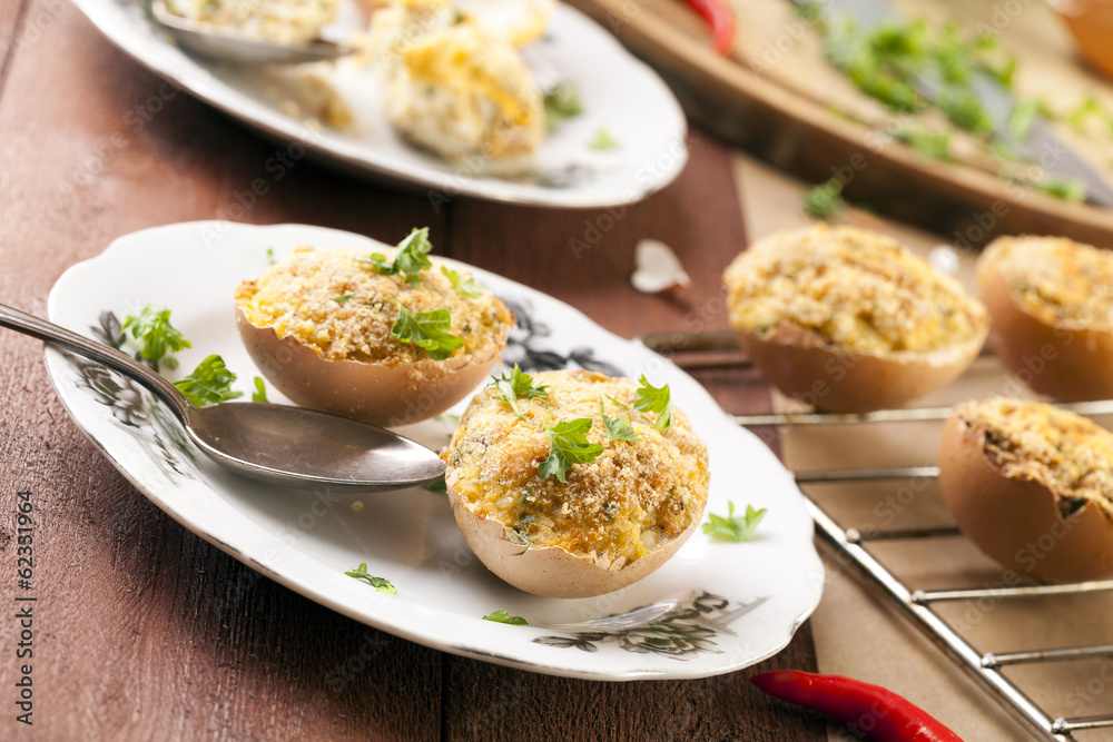 Baked eggs, stuffed with ham and parsley