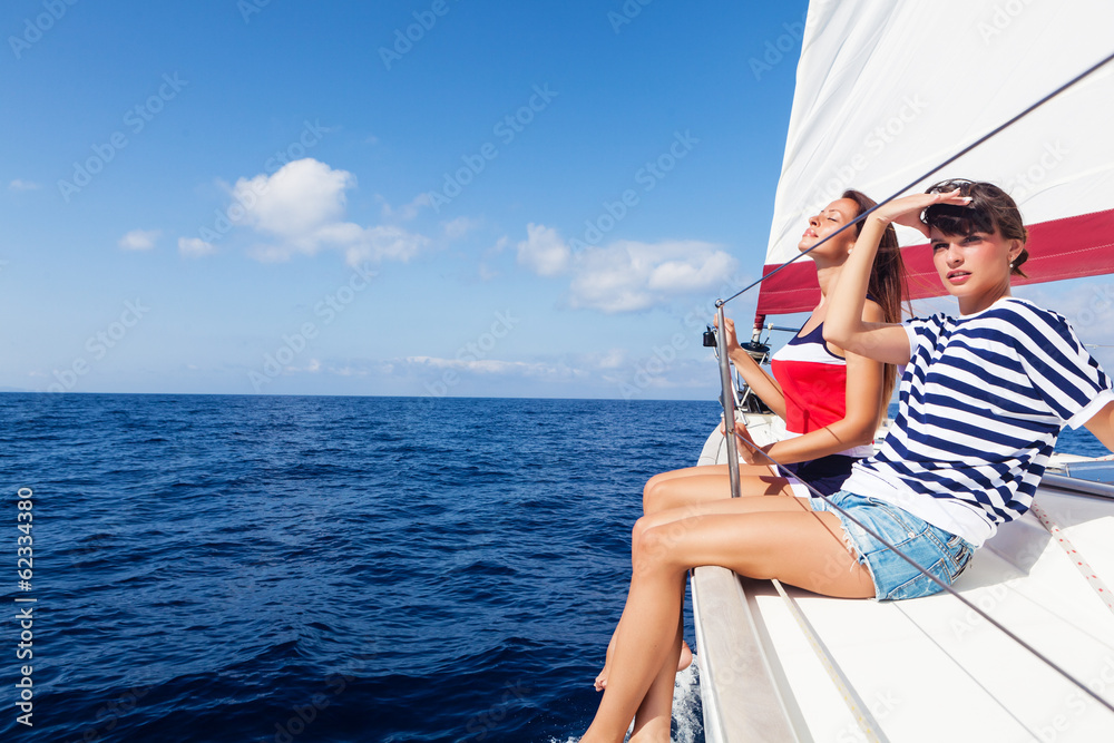 Happy women on the bow of a Sail Boat. Copy space