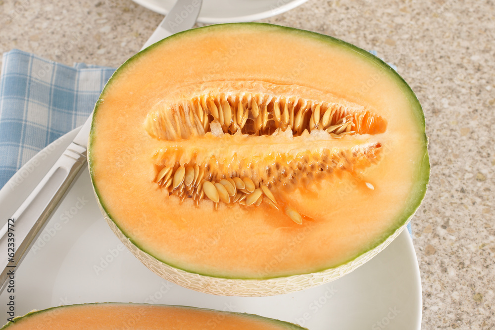 Cantaloupe sliced in half showing the seeds and flesh Cantaloupe sliced in half showing the seeds and flesh